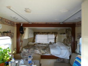 Bed slide in travel trailer